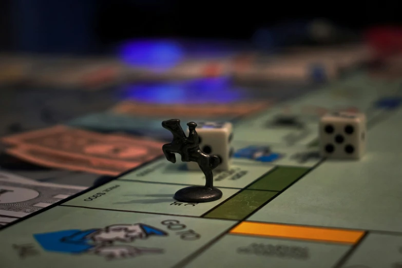 board game pieces lying on a board with dices on the table