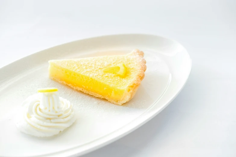 a piece of yellow cake is on a white plate