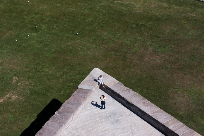 two people are standing outside on a building roof