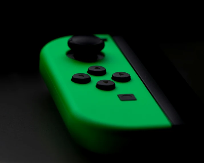 close up of the controllers ons on a green wii remote