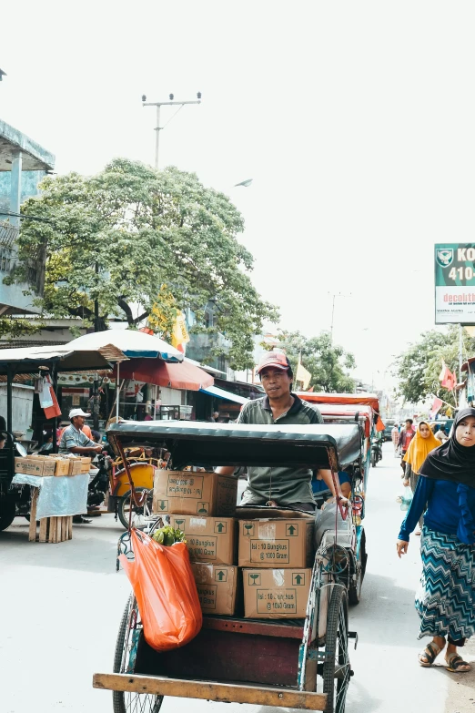 some people are shopping in the street while on foot in carts