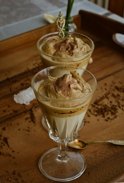 there are three desserts in glasses on the table