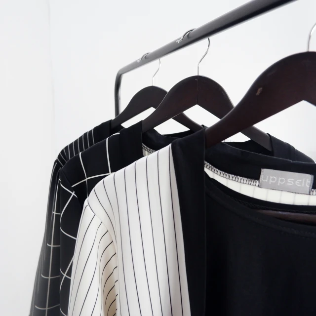 a closeup of shirts hanging on clothes racks