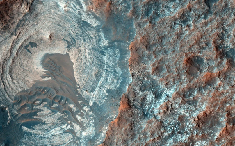 an overhead view of the area of mars, showing a patch of grass and a rock