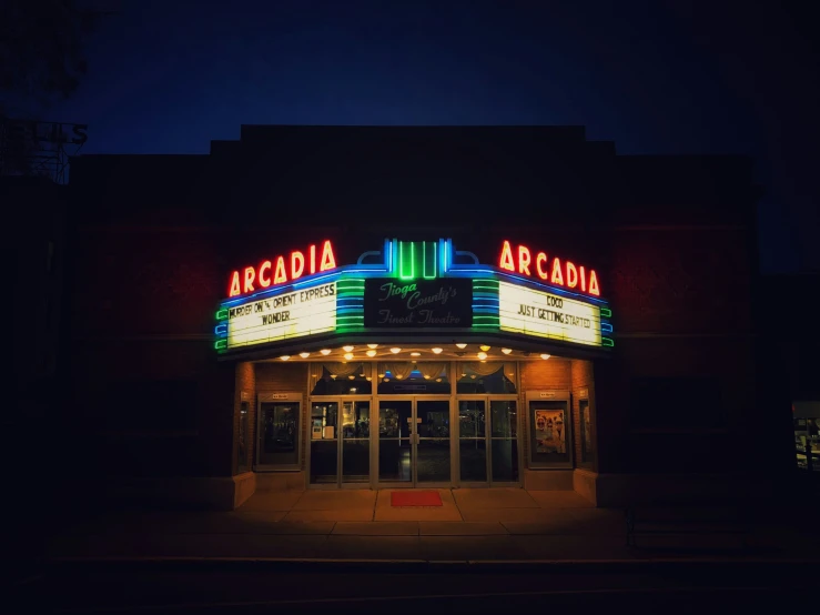 a movie theater with lights turned on and doors open