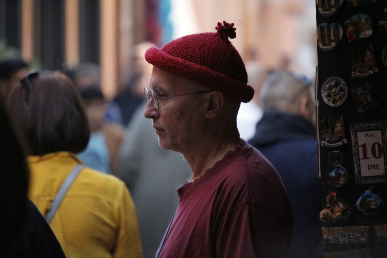 a man standing in a crowded city with lots of people