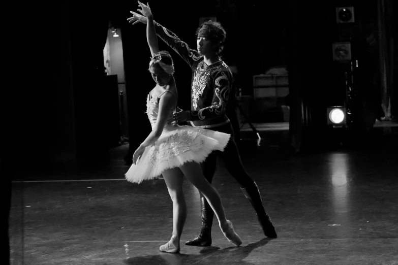 two girls are wearing ballet clothes and posing for a po