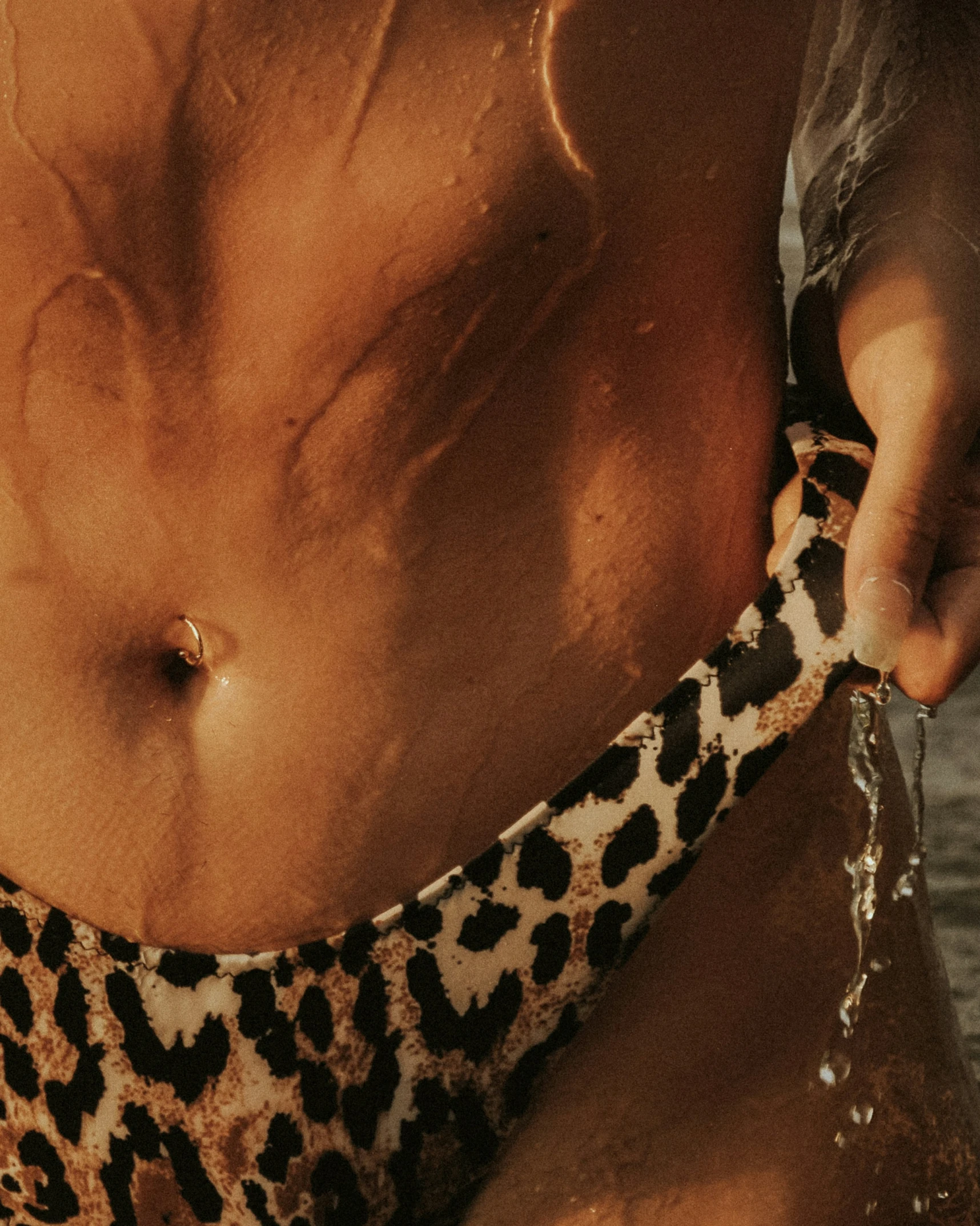 a man in leopard print holds onto his bikini