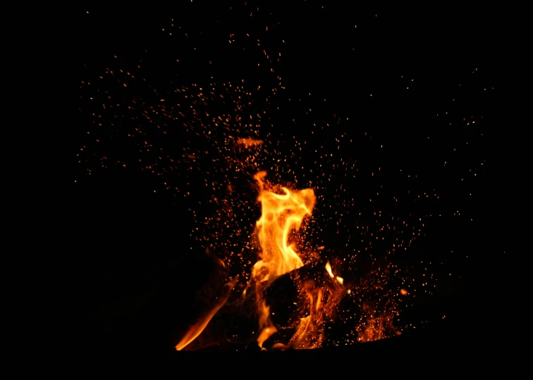 a bonfire that has fire in it on a black background