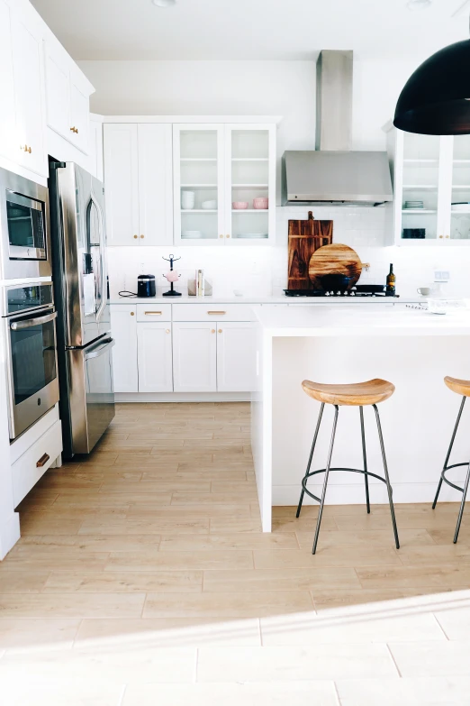 a kitchen that has a bar stool by the counter