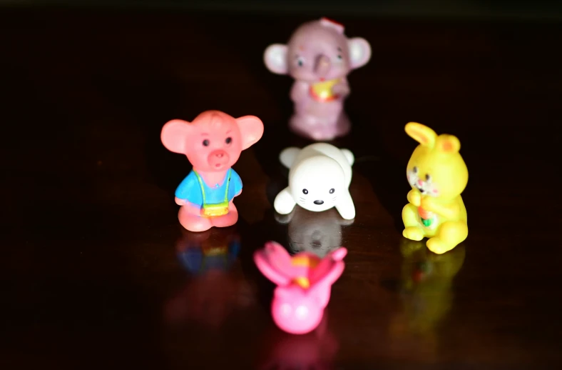 small toy animals with bright colors on a table