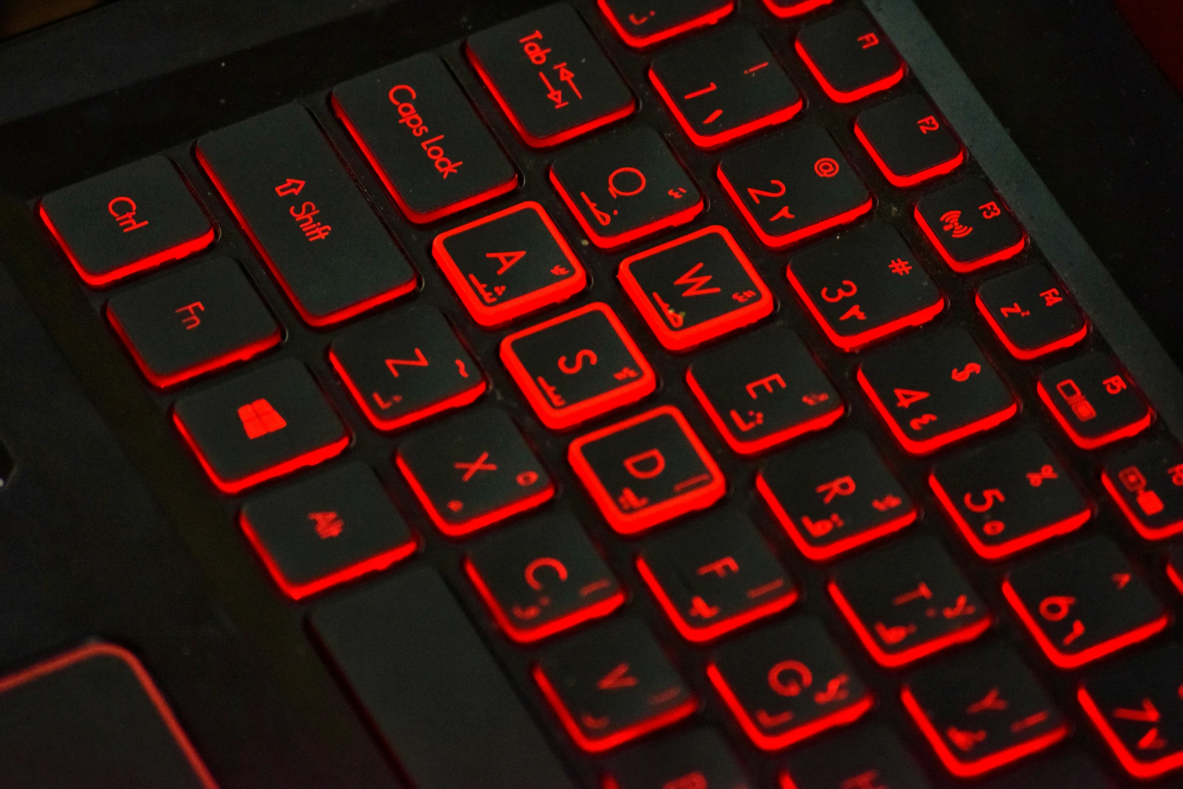 a dark colored keyboard is sitting on a red surface