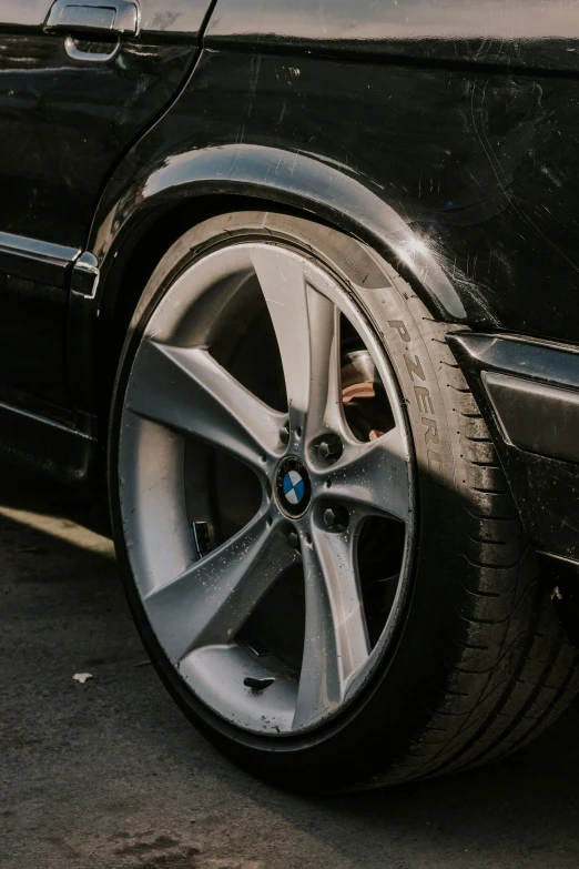the wheels of a parked black bmw sedan