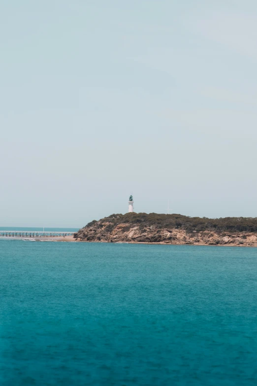 a lighthouse in the distance on an island