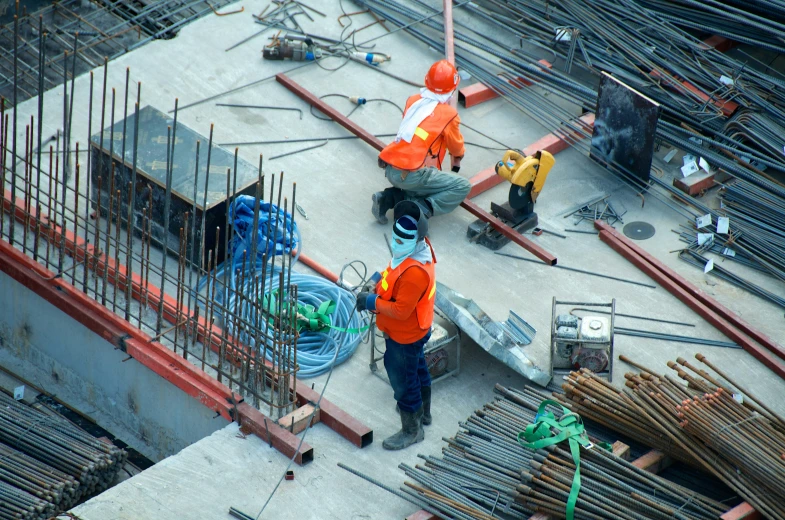 several men work on a building construction site