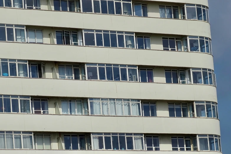 a very tall building with many windows and two planes flying by