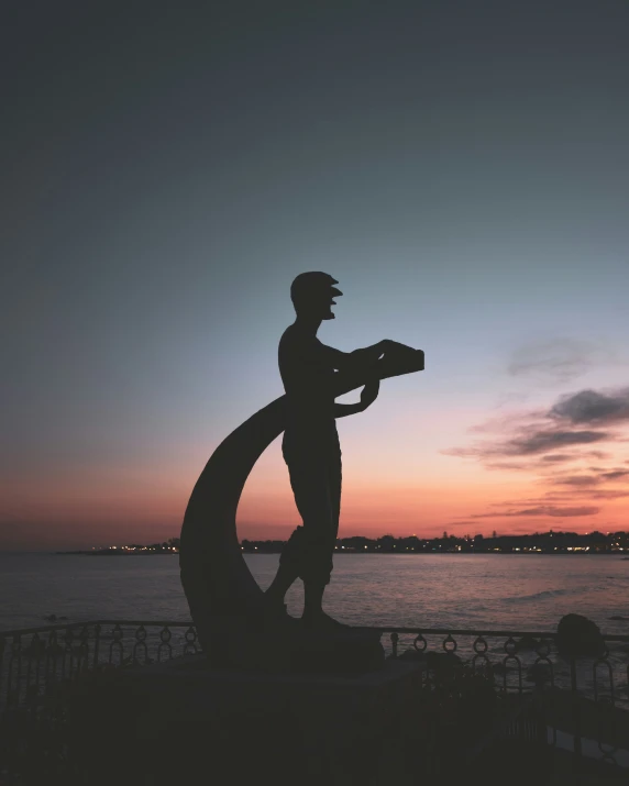 a statue that is sitting near the water