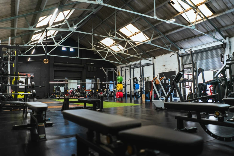 a room full of benches and rows of weight machines