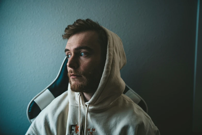 man in white hoodie looking away with an airplane on top