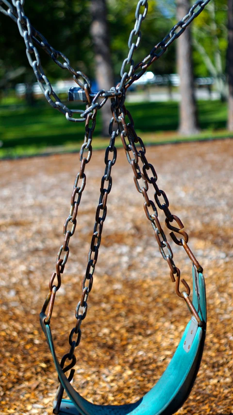 a blue swing has many chains hanging from it