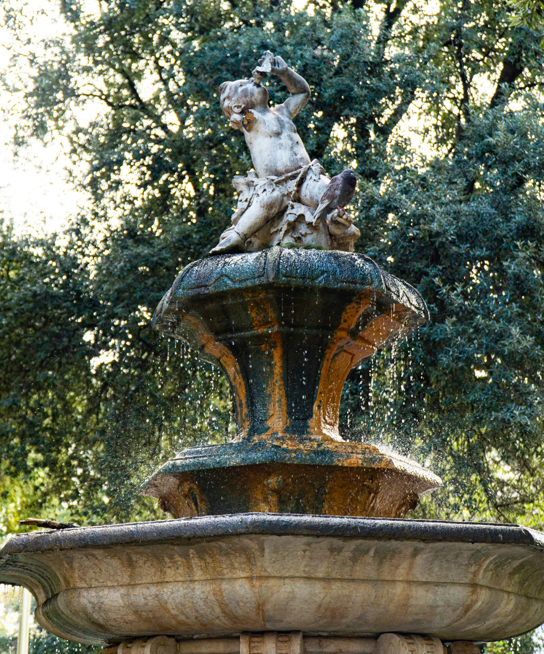 a water fountain with a statue on top of it