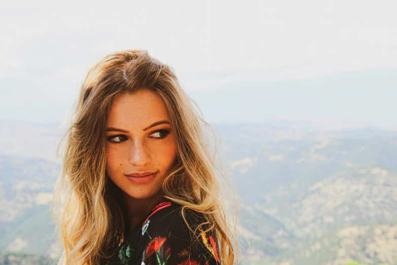 a beautiful blond woman looking down at the camera