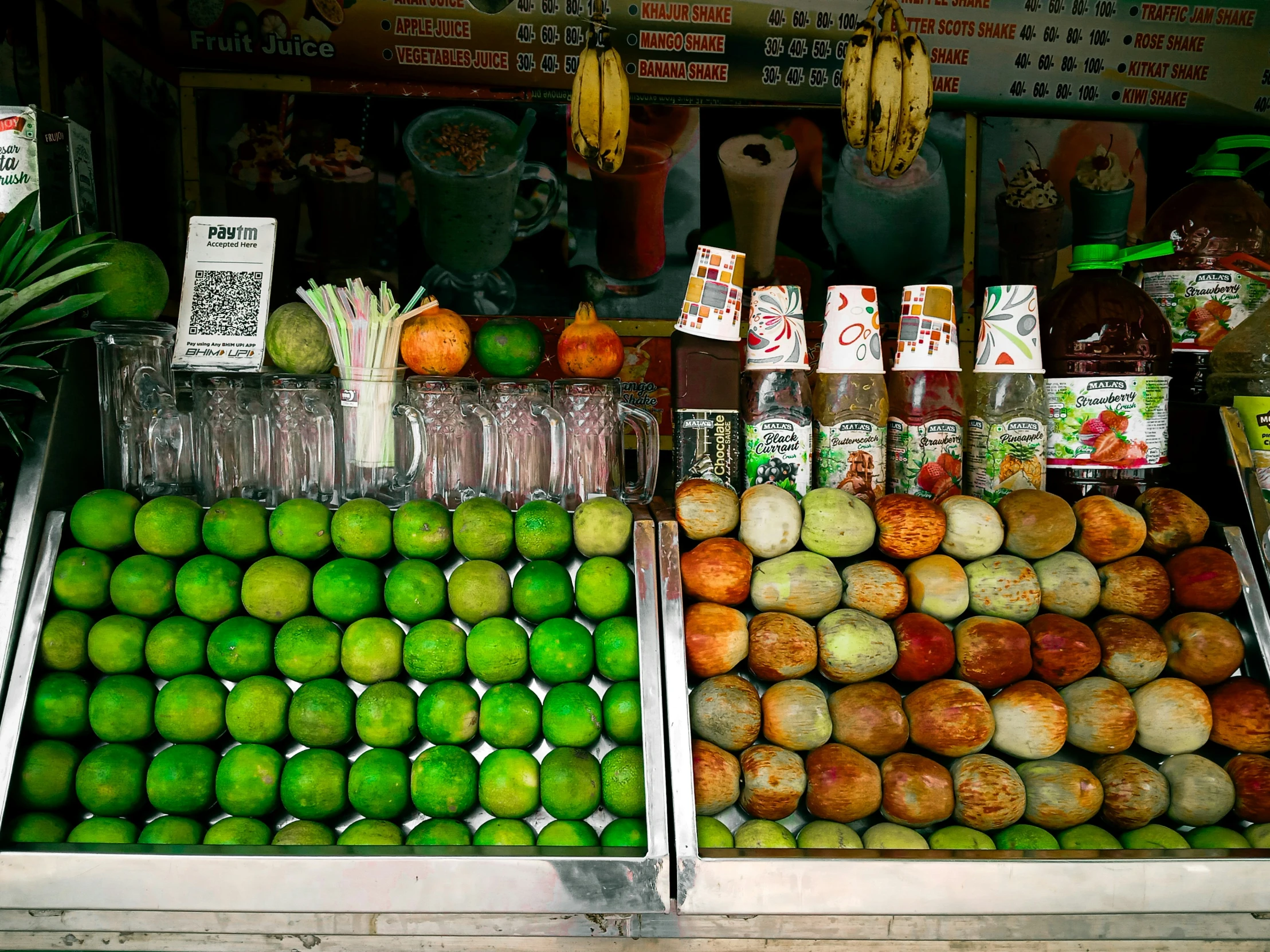 the fruits are sitting at the stand for sale