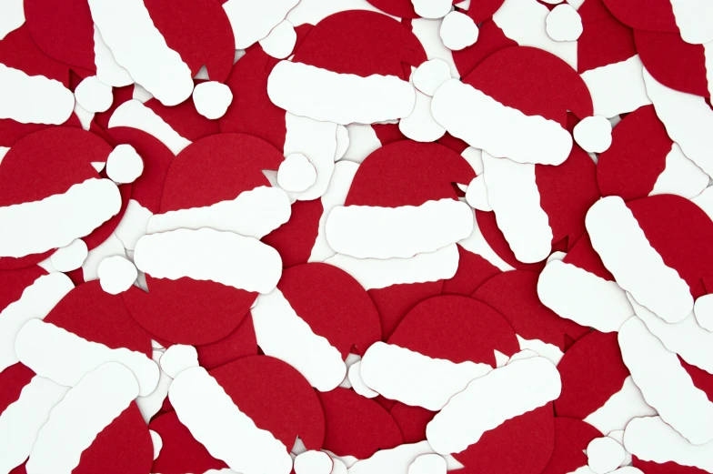 some paper santa clause and white and red shapes