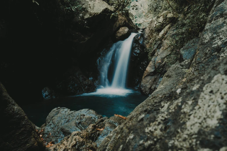 there is a small waterfall in a rocky cave