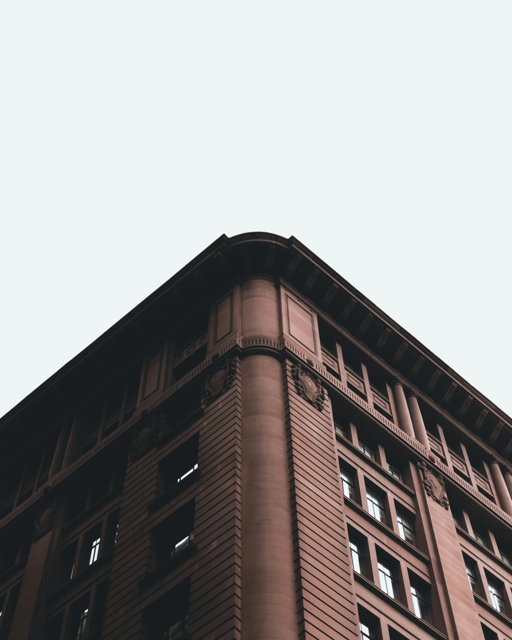 the top of an old, brown building that has many windows