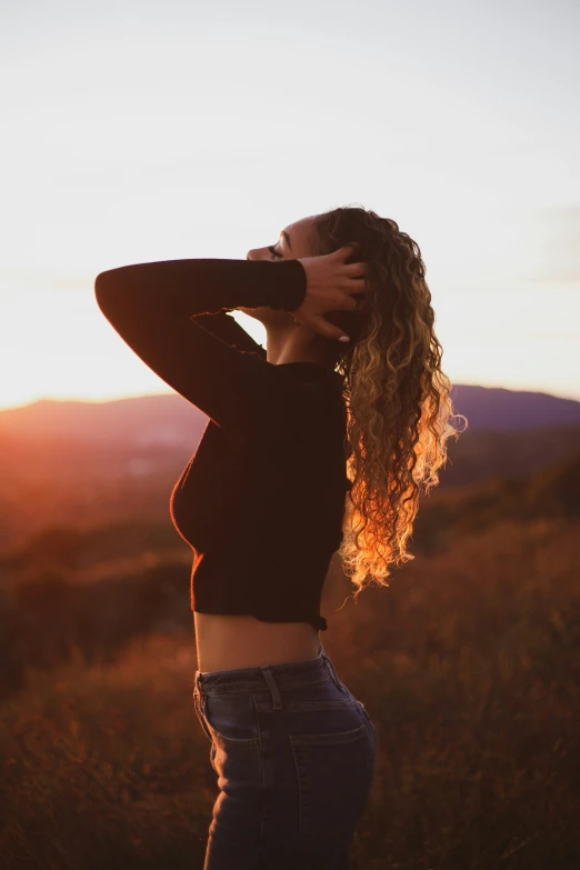 a person is in the evening holding their hair