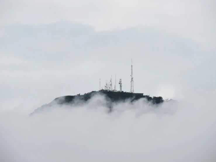 a view of a mountain with a large area with two antennas on top of it