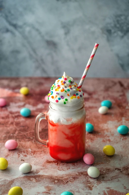 an iced drink topped with whipped cream and sprinkles