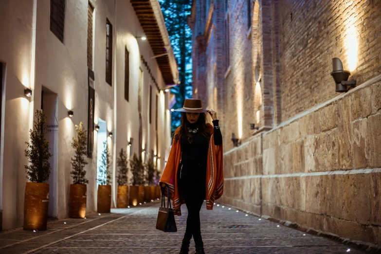 an image of a woman walking on the street at night