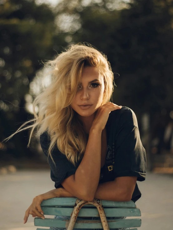 a blond woman poses with her handbag