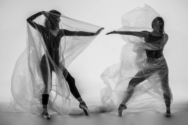 two woman with their hands wrapped around each other in dance pose