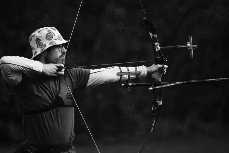 a woman standing with her hands and aiming a bow