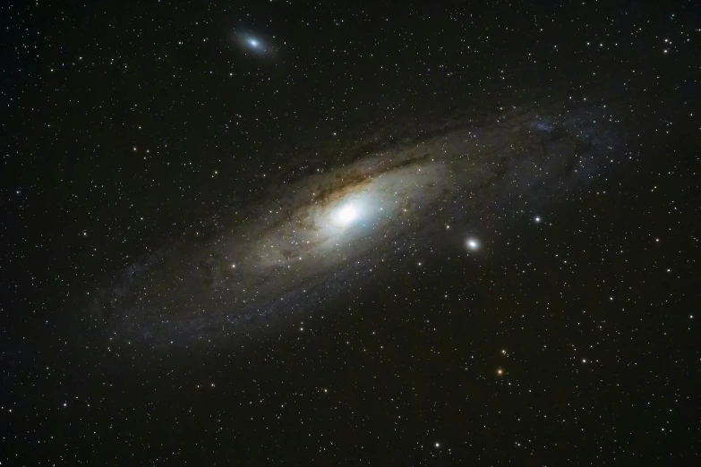 a very large star cluster sitting on top of a cloud filled sky