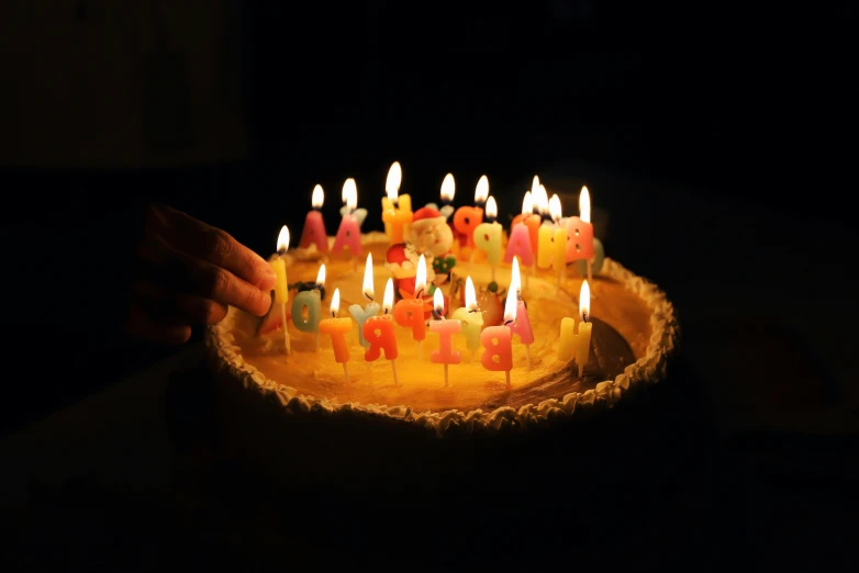 many birthday candles are placed on a cake