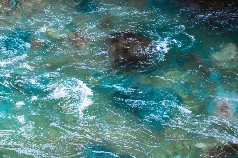 water from above shows blue and green colored rocks