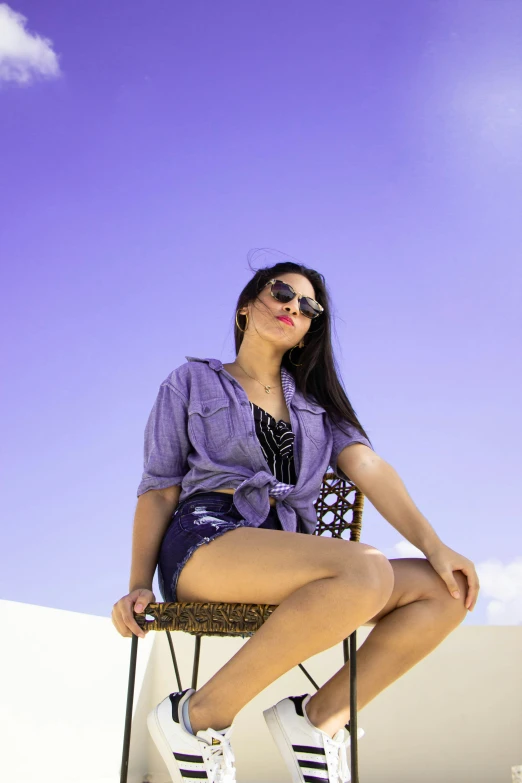 a woman is sitting in a chair while posing for a picture