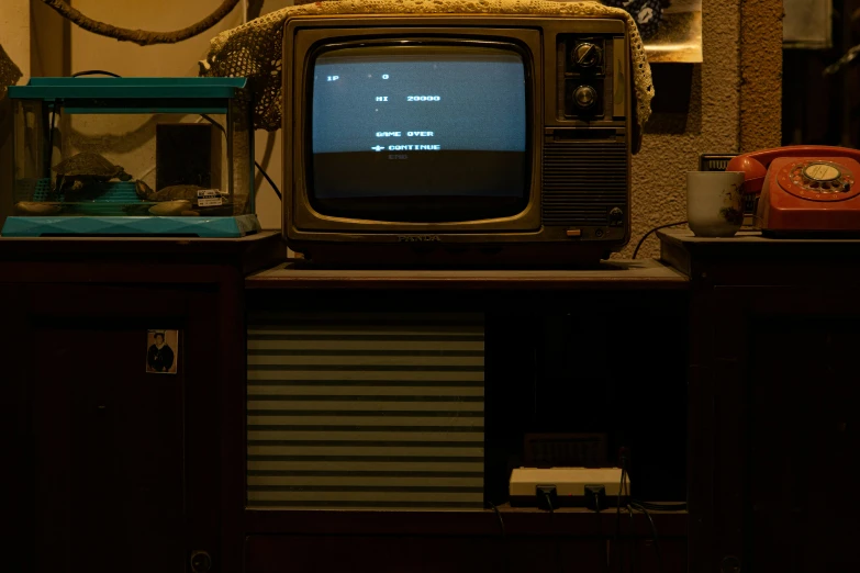 an old tv sits on top of a dresser