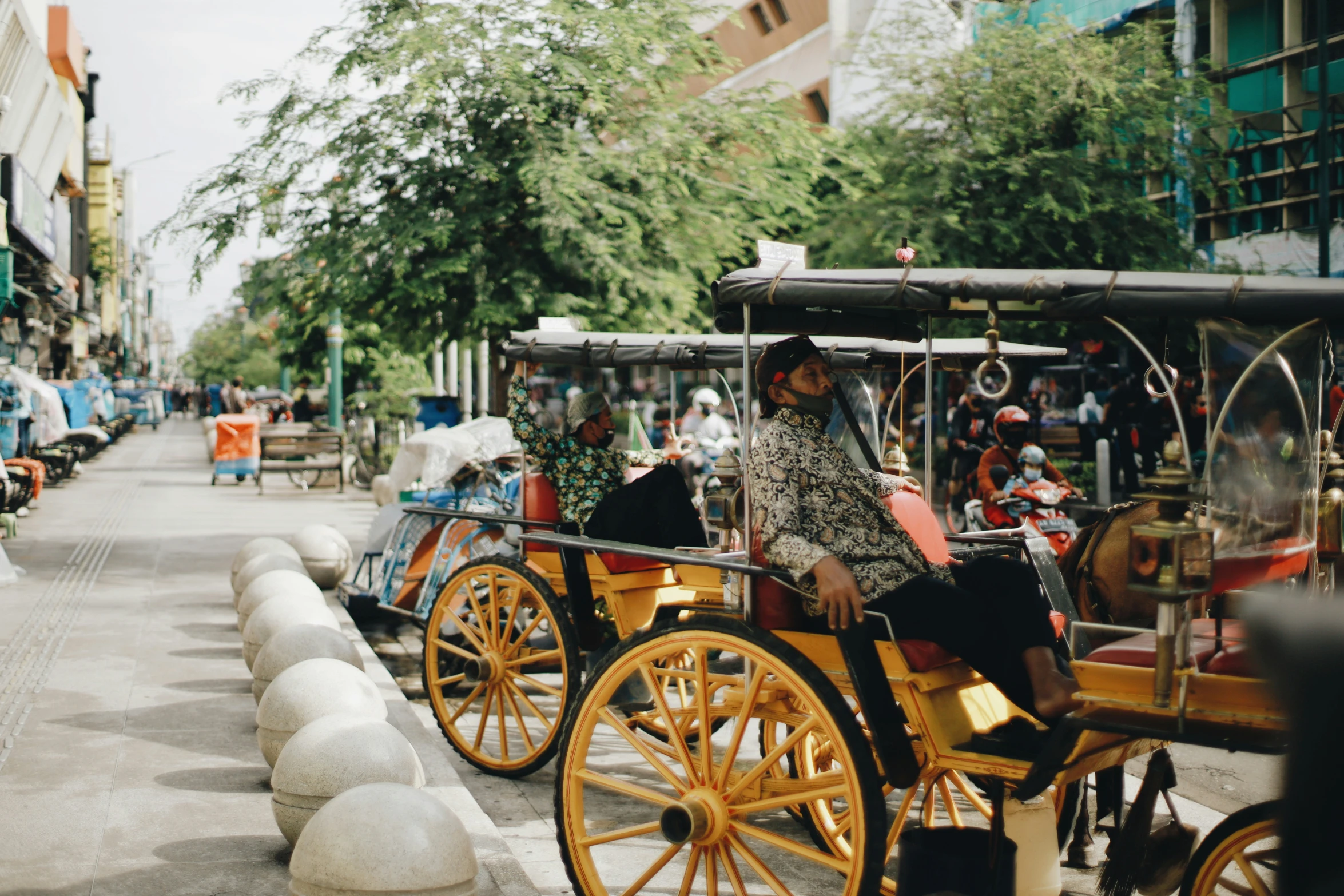 some very pretty yellow horses pulling people on a road