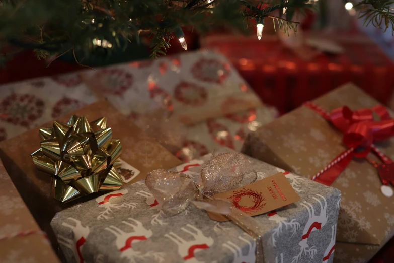 two presents under the christmas tree are under a holiday ornament