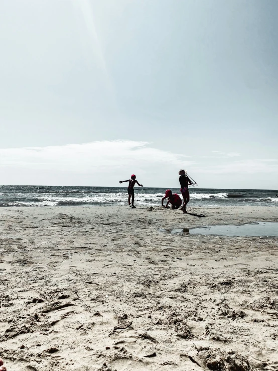 two people are flying kites on a beach