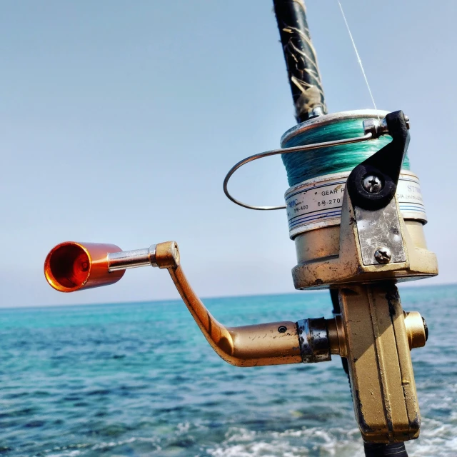 a metal spool attached to a boat by some water