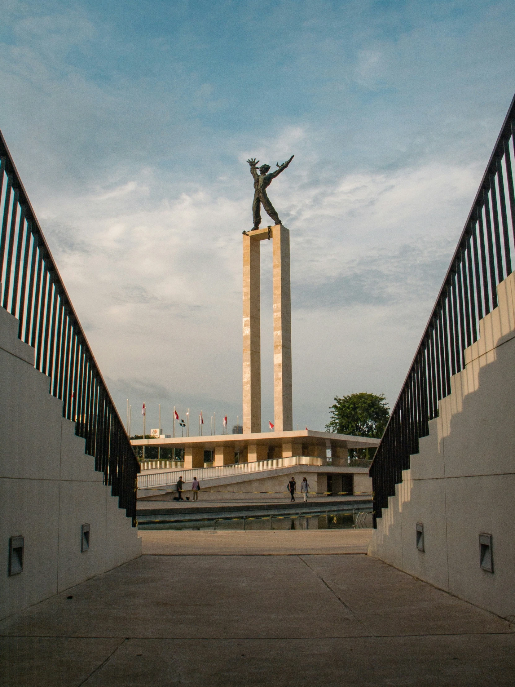 the monument is surrounded by stone steps and has a clock tower