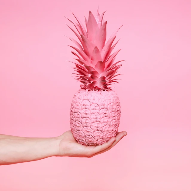 a pink pineapple has been made out of strawberries