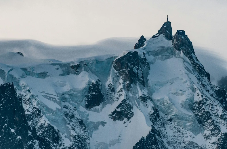 the tops of mountains are covered in snow