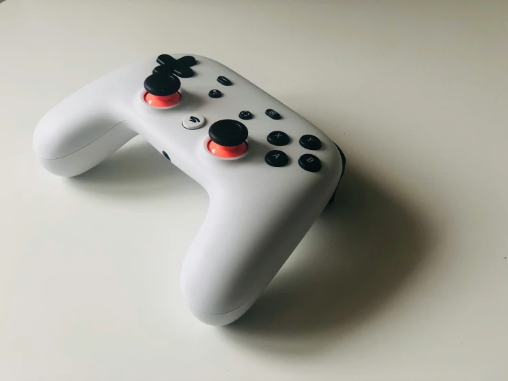 a white controller that has four ons on it